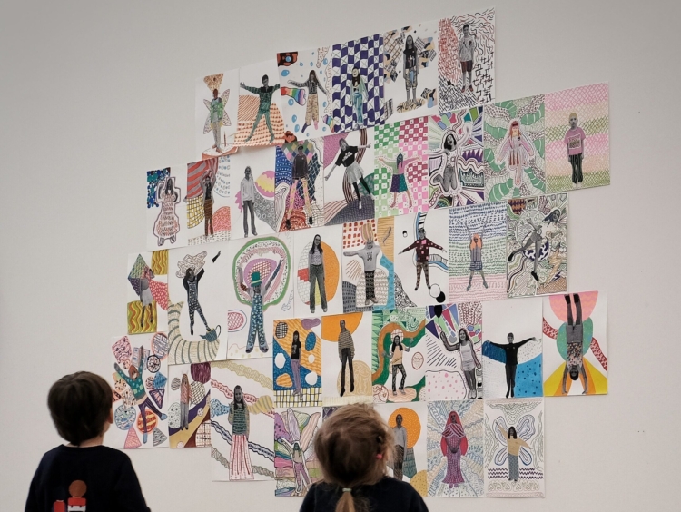 Kids looking at collages realised in various children's workshops at Mudam Luxembourg.