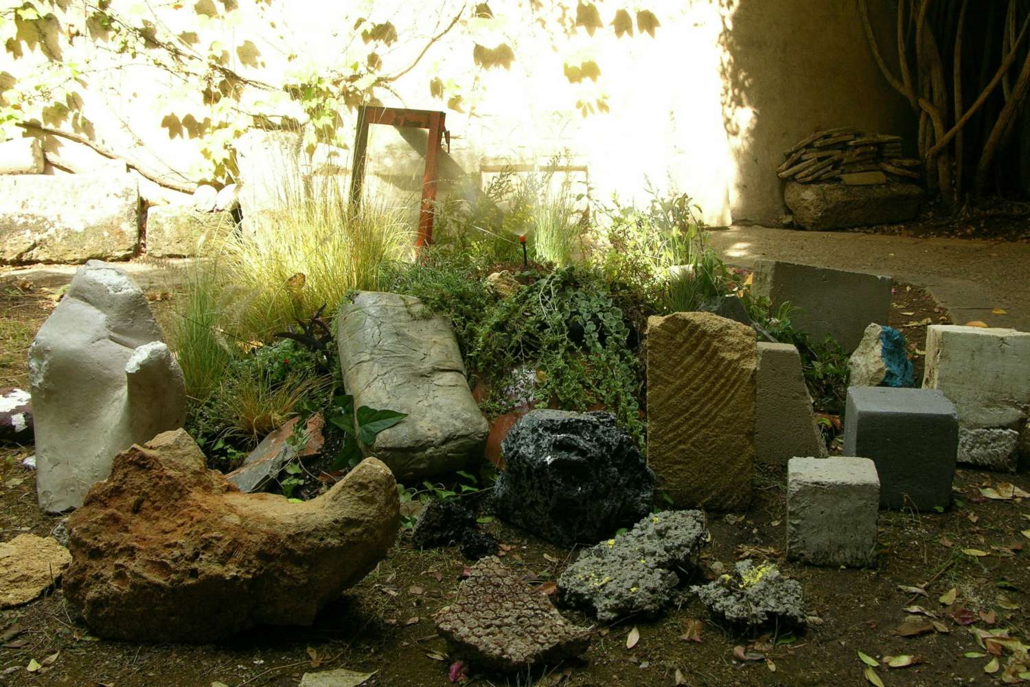 Diverse stones gathered ion a garden.